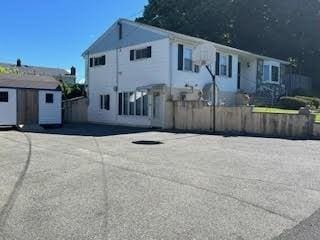 view of front of home featuring a storage shed