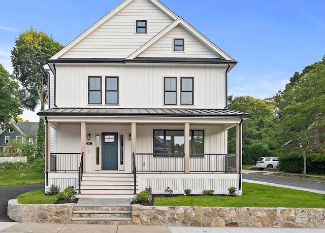 82 Oakland St, Melrose, MA 02176 - modern inspired farmhouse with a standing seam roof, a porch, and a front yard