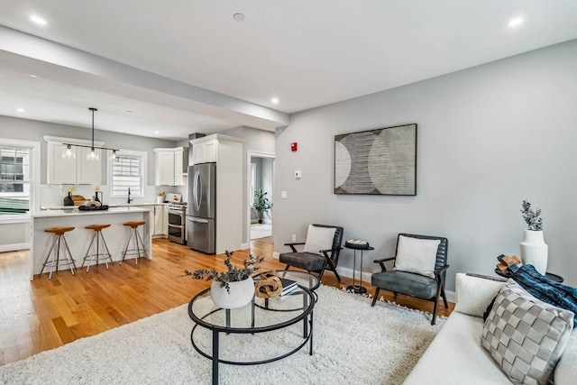 living room featuring light hardwood / wood-style floors and sink