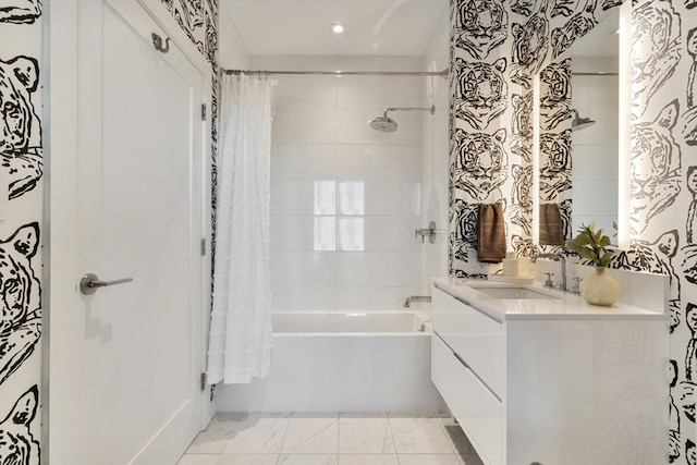 full bath featuring vanity and shower / bath combo