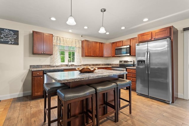 37 Leach Ave, Brockton, MA 02301 - kitchen with stainless steel appliances, a kitchen breakfast bar, light wood-type flooring, recessed lighting, and a center island