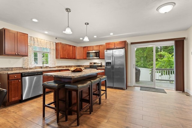 37 Leach Ave, Brockton, MA 02301 - kitchen with appliances with stainless steel finishes, recessed lighting, a breakfast bar area, decorative light fixtures, and a center island
