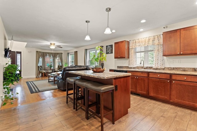 37 Leach Ave, Brockton, MA 02301 - kitchen with a breakfast bar, light wood finished floors, a kitchen island, hanging light fixtures, and open floor plan