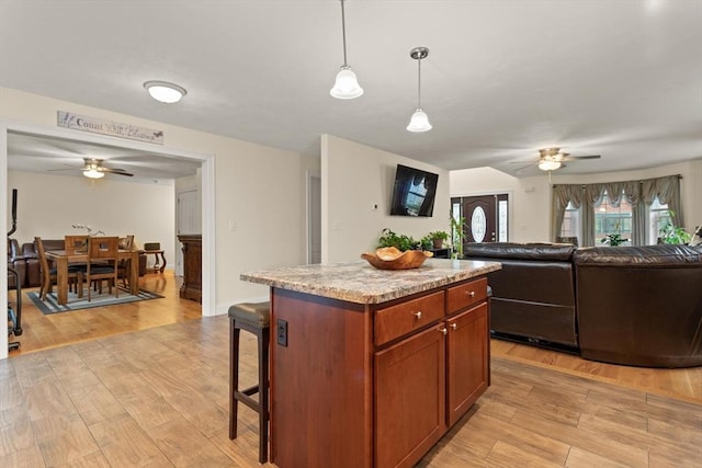 37 Leach Ave, Brockton, MA 02301 - kitchen featuring a ceiling fan, light wood-type flooring, open floor plan, and a breakfast bar
