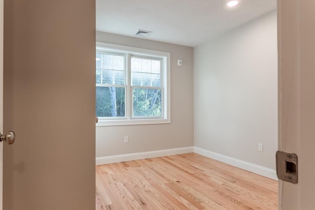 spare room featuring light hardwood / wood-style flooring