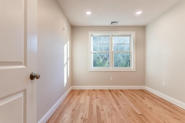 spare room featuring light hardwood / wood-style flooring