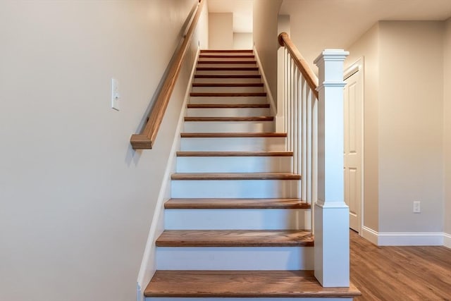 stairway featuring hardwood / wood-style flooring