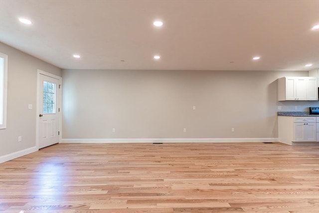 unfurnished living room with light wood-type flooring