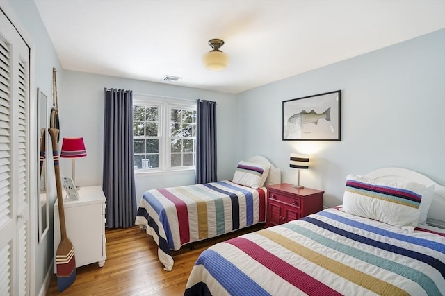 bedroom with hardwood / wood-style flooring