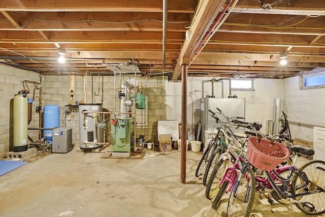 basement with water heater and fridge