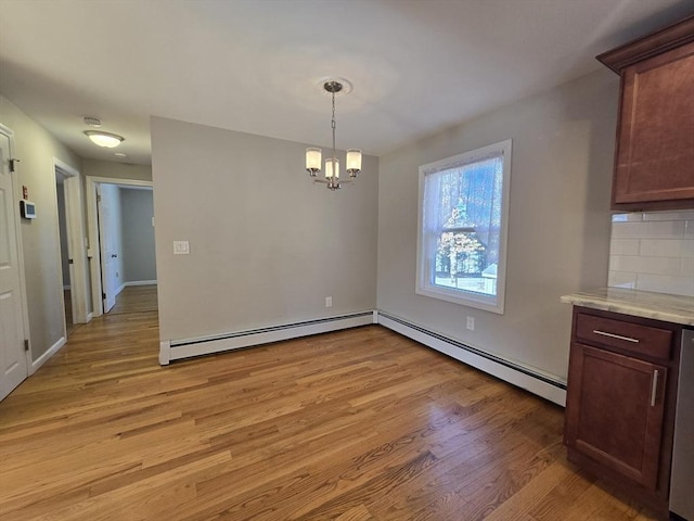 unfurnished dining area with a baseboard radiator, a chandelier, and light hardwood / wood-style flooring