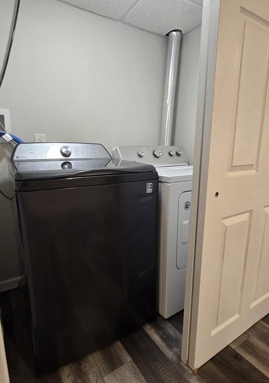 washroom with dark hardwood / wood-style floors and washer and clothes dryer