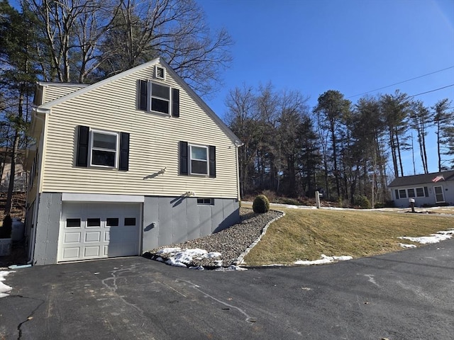 view of side of property featuring central AC unit and a garage