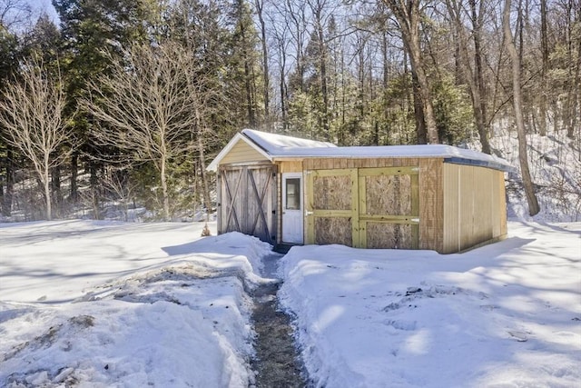 snow covered structure with an outdoor structure