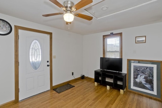 entrance foyer with light wood-type flooring, ceiling fan, and baseboards