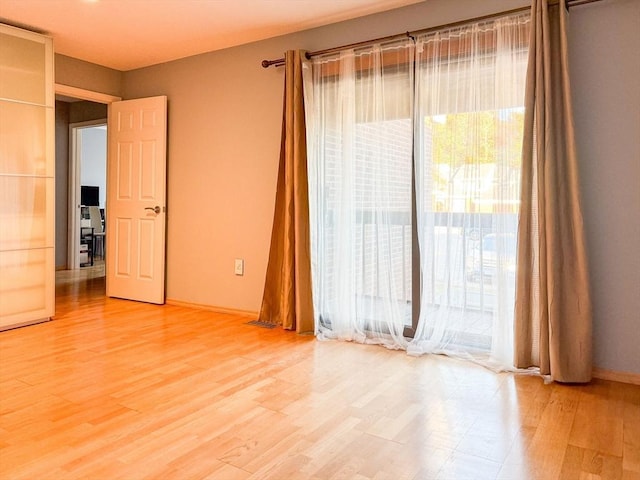 unfurnished room with hardwood / wood-style flooring