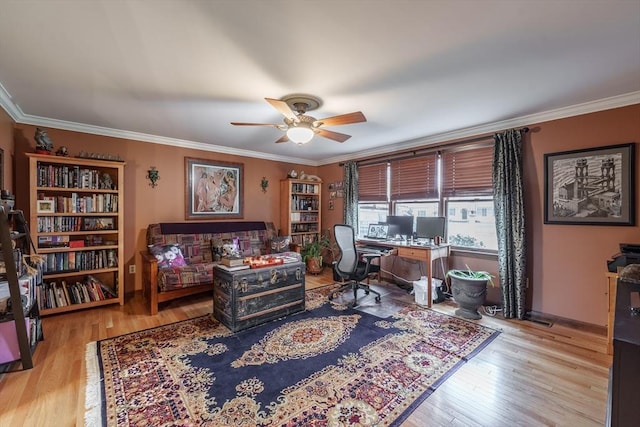 home office featuring a ceiling fan, ornamental molding, baseboards, and wood finished floors