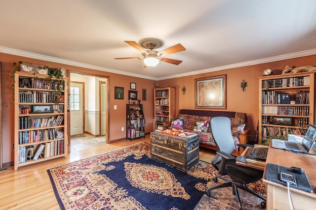 office space featuring baseboards, wood finished floors, a ceiling fan, and ornamental molding