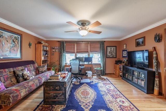 living area with light wood finished floors, a ceiling fan, and ornamental molding