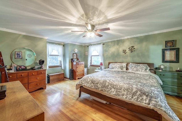 bedroom featuring a ceiling fan, light wood finished floors, and crown molding