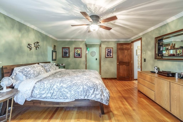 bedroom with crown molding, light wood-style flooring, and ceiling fan