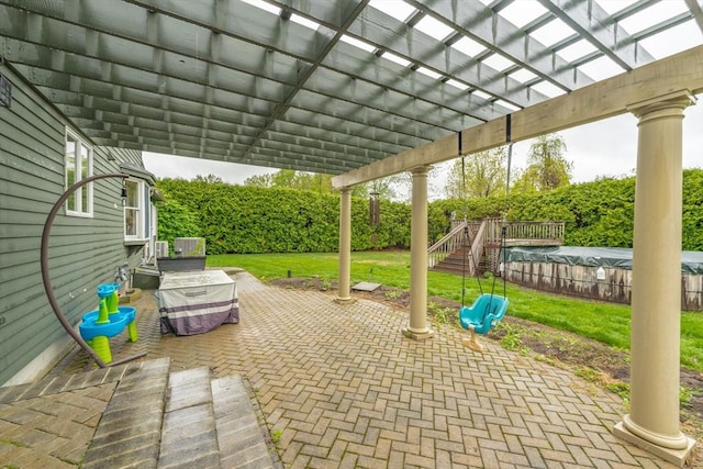 view of patio with a pergola and fence