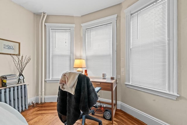 home office featuring radiator and baseboards