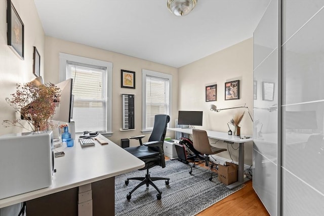 home office with light wood-style flooring