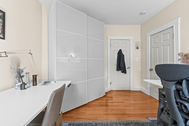 office with light wood-style flooring
