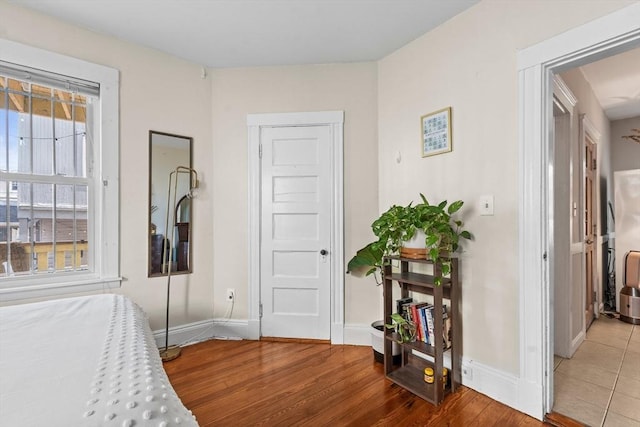 bedroom with baseboards and wood finished floors