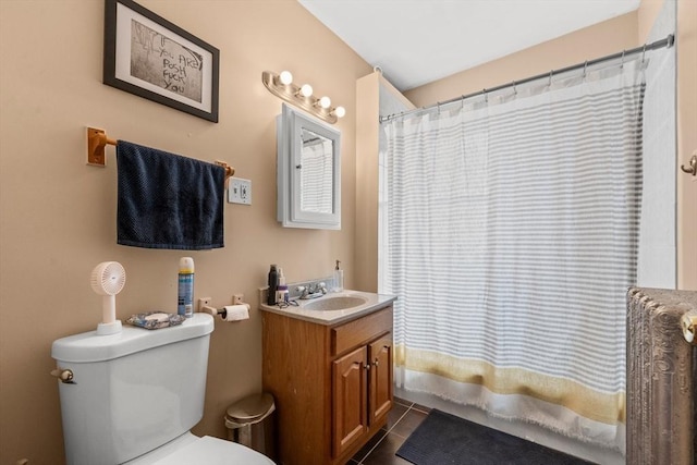 full bath with toilet, tile patterned floors, shower / tub combo, and vanity