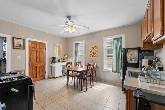 dining area featuring ceiling fan and light tile patterned floors
