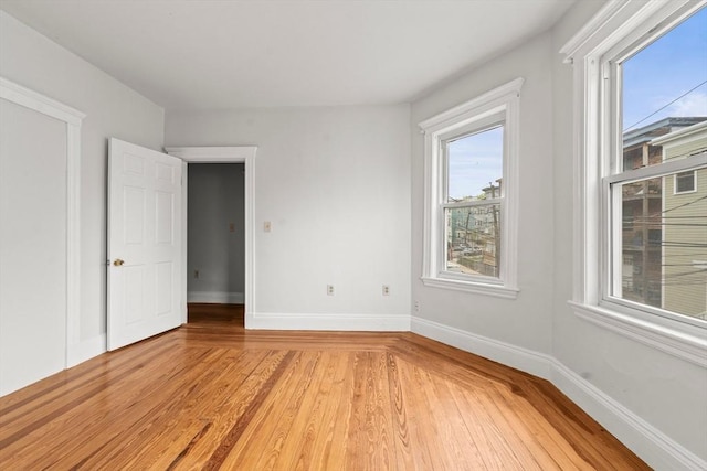 unfurnished bedroom featuring baseboards and light wood finished floors