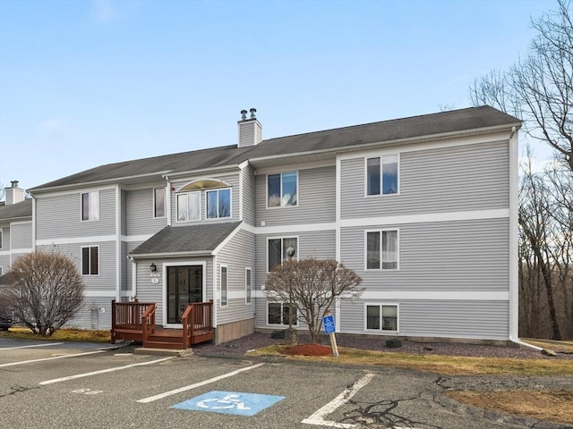 view of building exterior with uncovered parking