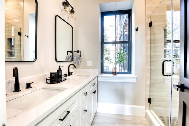 bathroom featuring vanity, a shower with door, and plenty of natural light