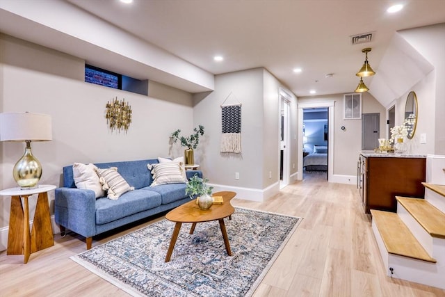 living room featuring light hardwood / wood-style flooring and lofted ceiling