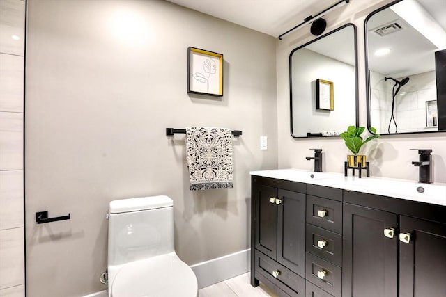 bathroom featuring tile patterned floors, vanity, and toilet