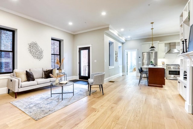 living room with light wood-type flooring and ornamental molding