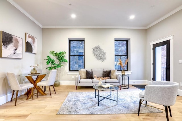 living room with light hardwood / wood-style floors and ornamental molding