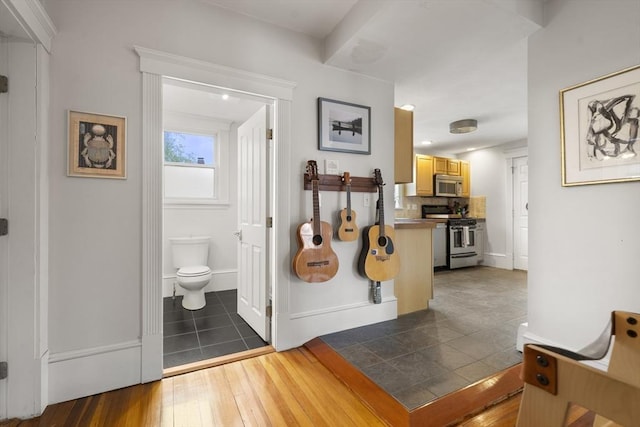 hallway with baseboards and dark wood finished floors
