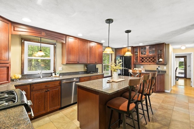 5-R Valeda, Rehoboth, MA 02769 - kitchen with appliances with stainless steel finishes, a sink, glass insert cabinets, a center island, and a kitchen bar