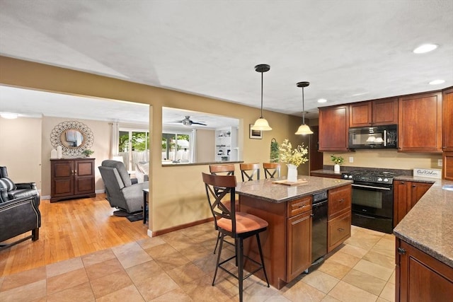 5-R Valeda, Rehoboth, MA 02769 - kitchen with gas stove, black microwave, a breakfast bar area, open floor plan, and recessed lighting