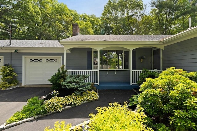5-R Valeda, Rehoboth, MA 02769 - view of front of house featuring an attached garage, covered porch, a chimney, and asphalt driveway