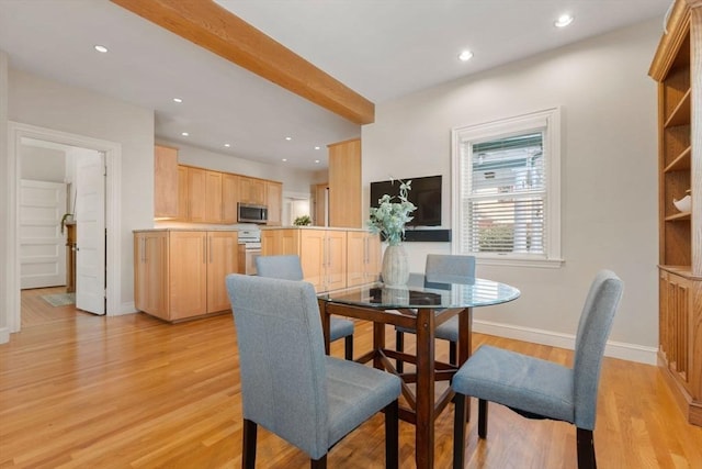 dining room with beam ceiling and light hardwood / wood-style flooring