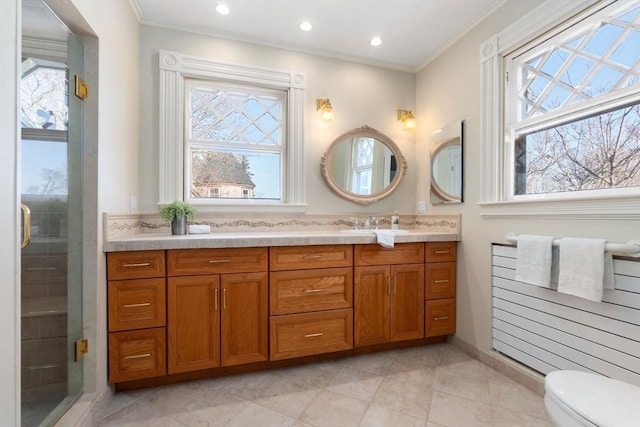 bathroom with crown molding, toilet, vanity, and walk in shower