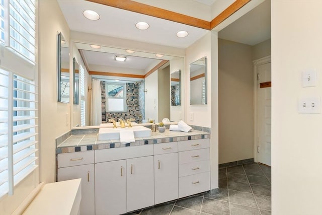 bathroom featuring walk in shower, vanity, and tile patterned flooring