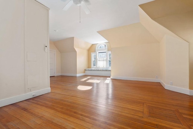 additional living space featuring ceiling fan, vaulted ceiling, and light hardwood / wood-style flooring