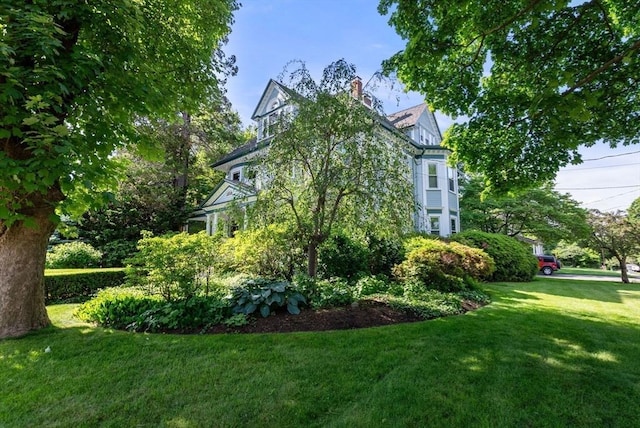 view of side of property with a lawn