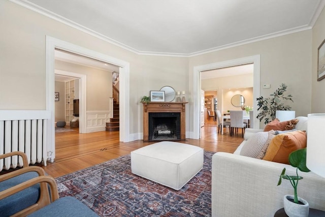 living room with ornamental molding and hardwood / wood-style floors