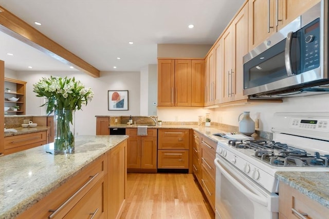 kitchen featuring white gas stove, light stone counters, light hardwood / wood-style flooring, light brown cabinets, and beamed ceiling